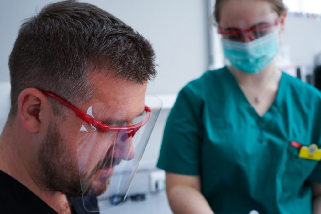 Sean Daly performing treatment for tooth fillings.